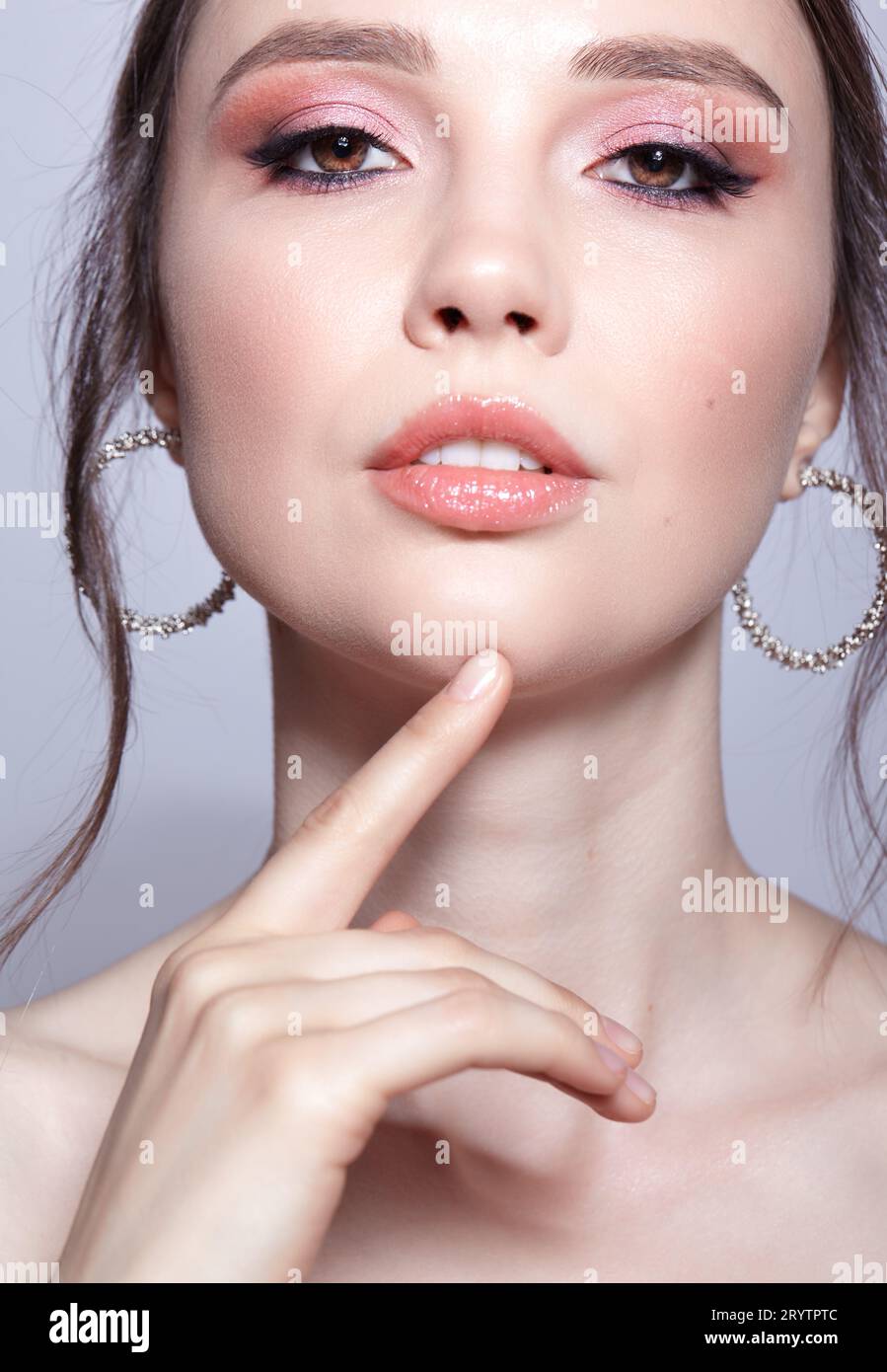 Closeup shot of human woman face. Female with face and eyes beauty makeup with pink smoky eyes eye shadows Stock Photo