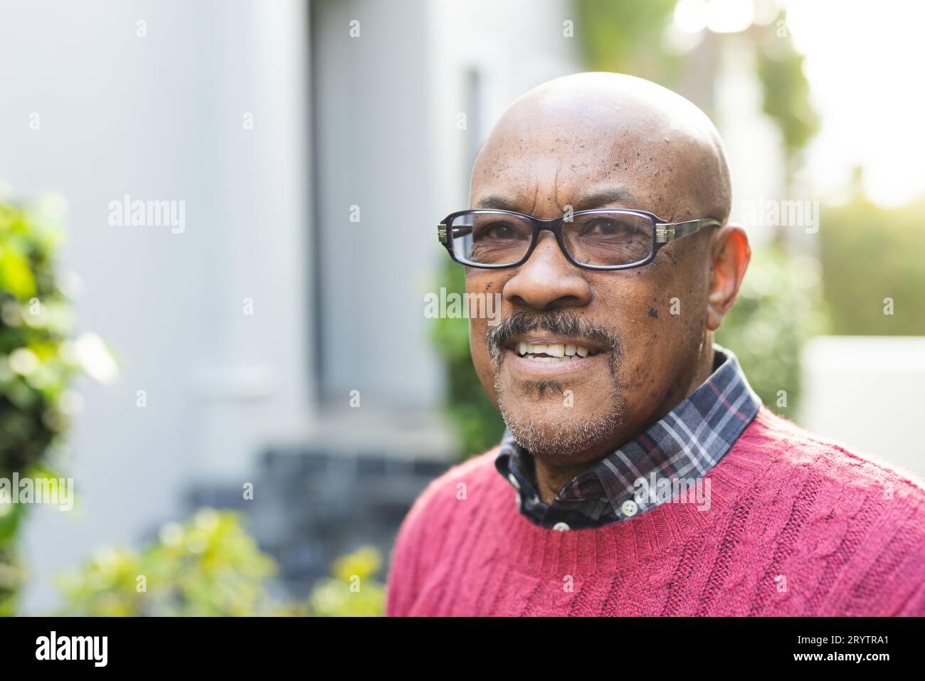 Happy senior african american man wearing glasses and red jumper ...