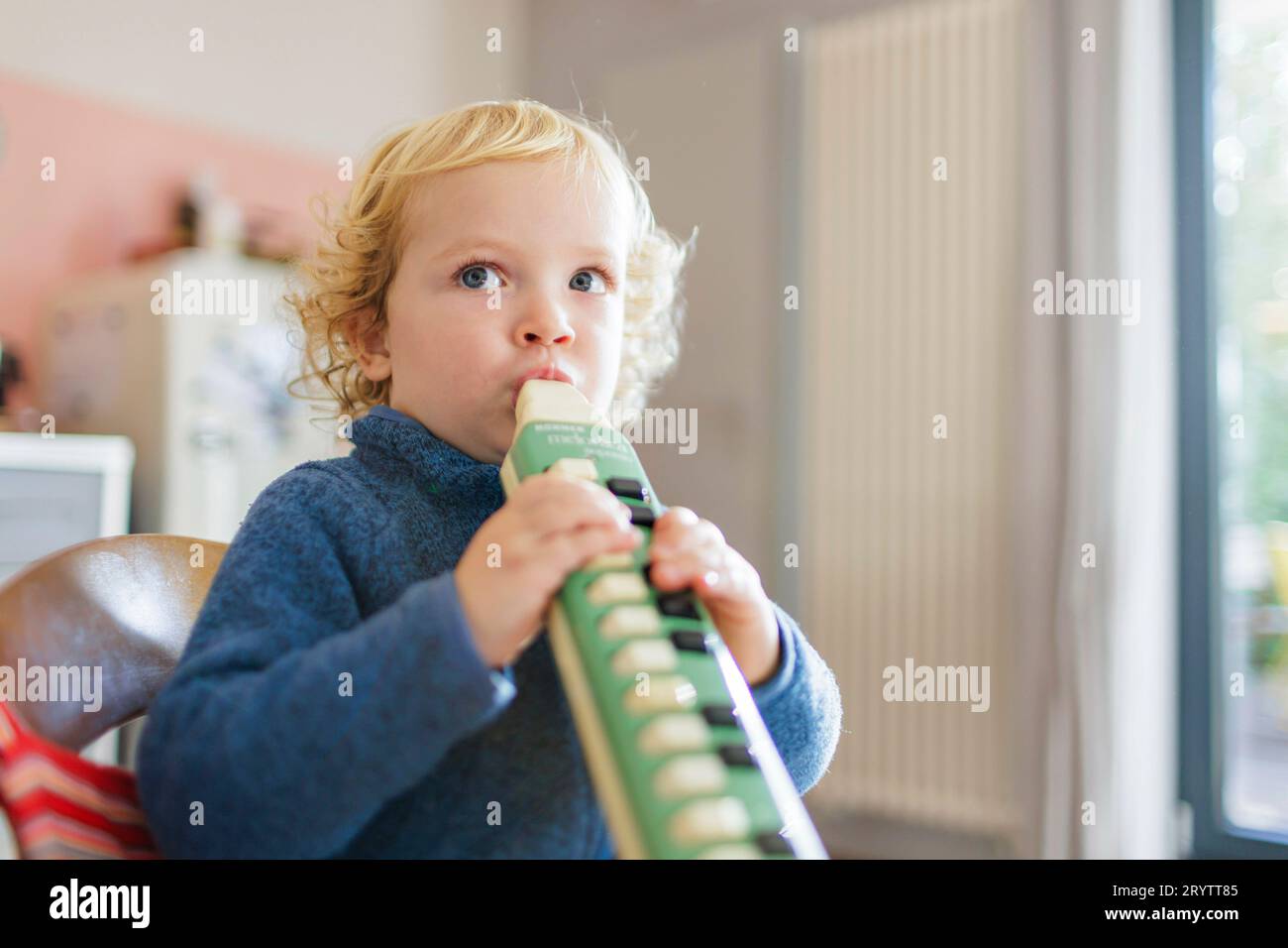Topic Child plays a Hoehner melodica Stock Photo Alamy
