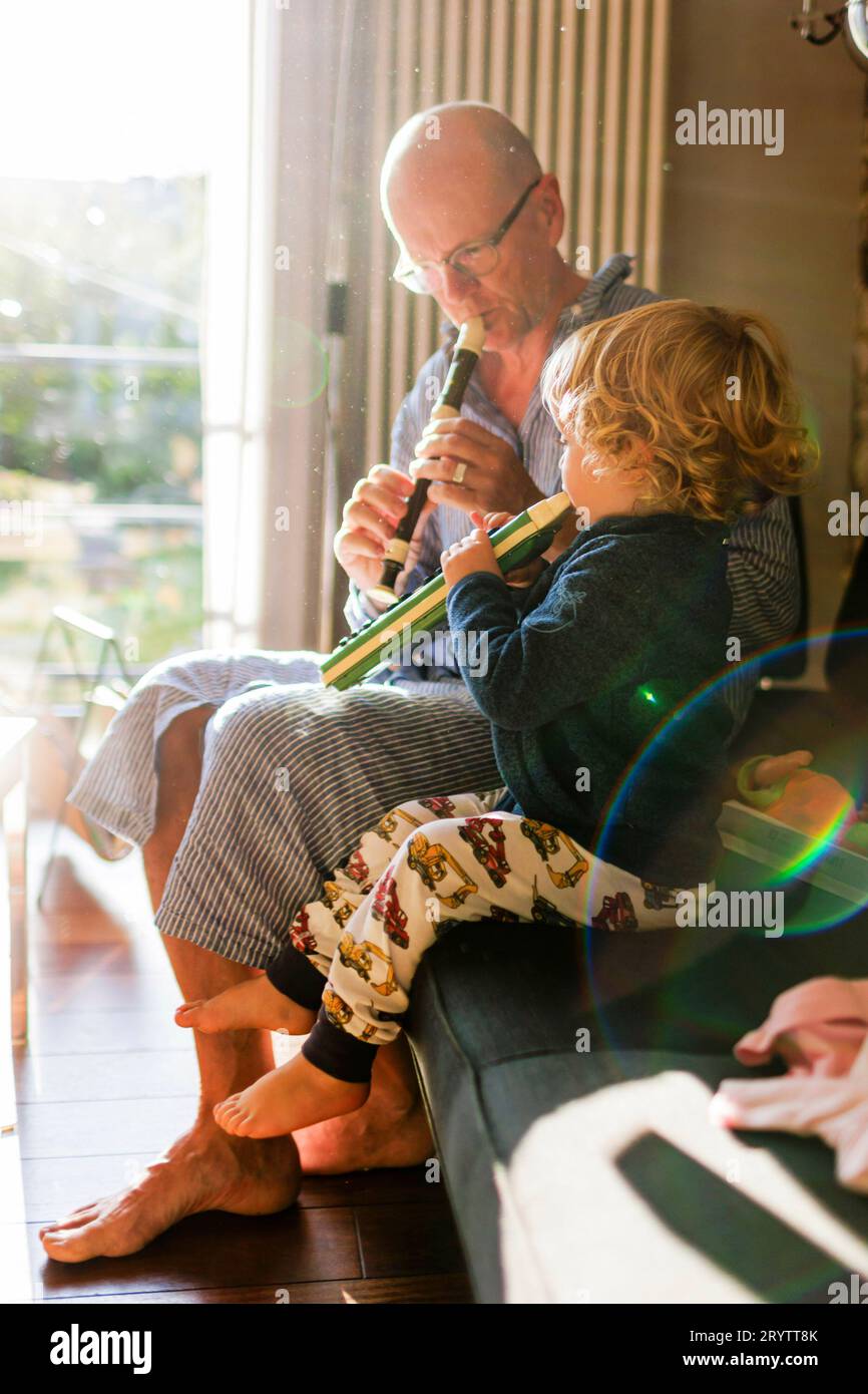 Theme Family concert, child plays on a Hoehner melodica. Grandfather
