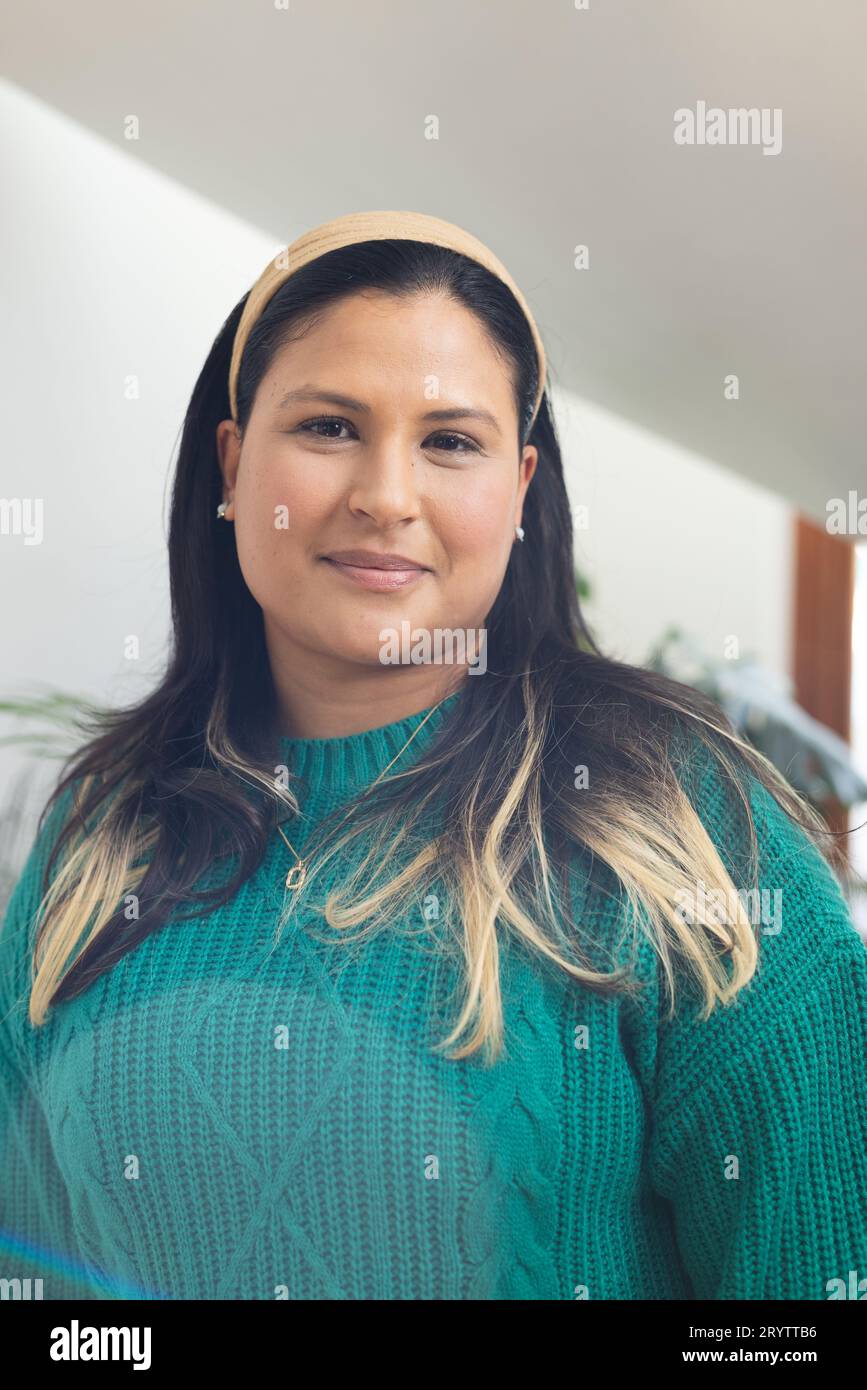 Portrait of happy biracial woman with long,straight hair standing in ...