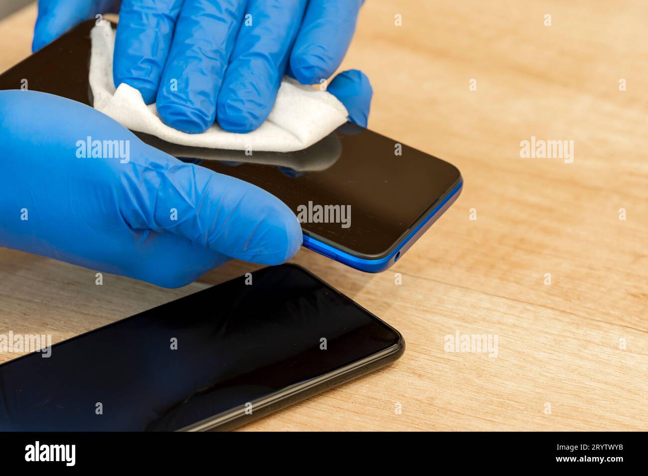 Hands in sterile gloves. Wet disinfectant wipe, napkin. Mobile phone