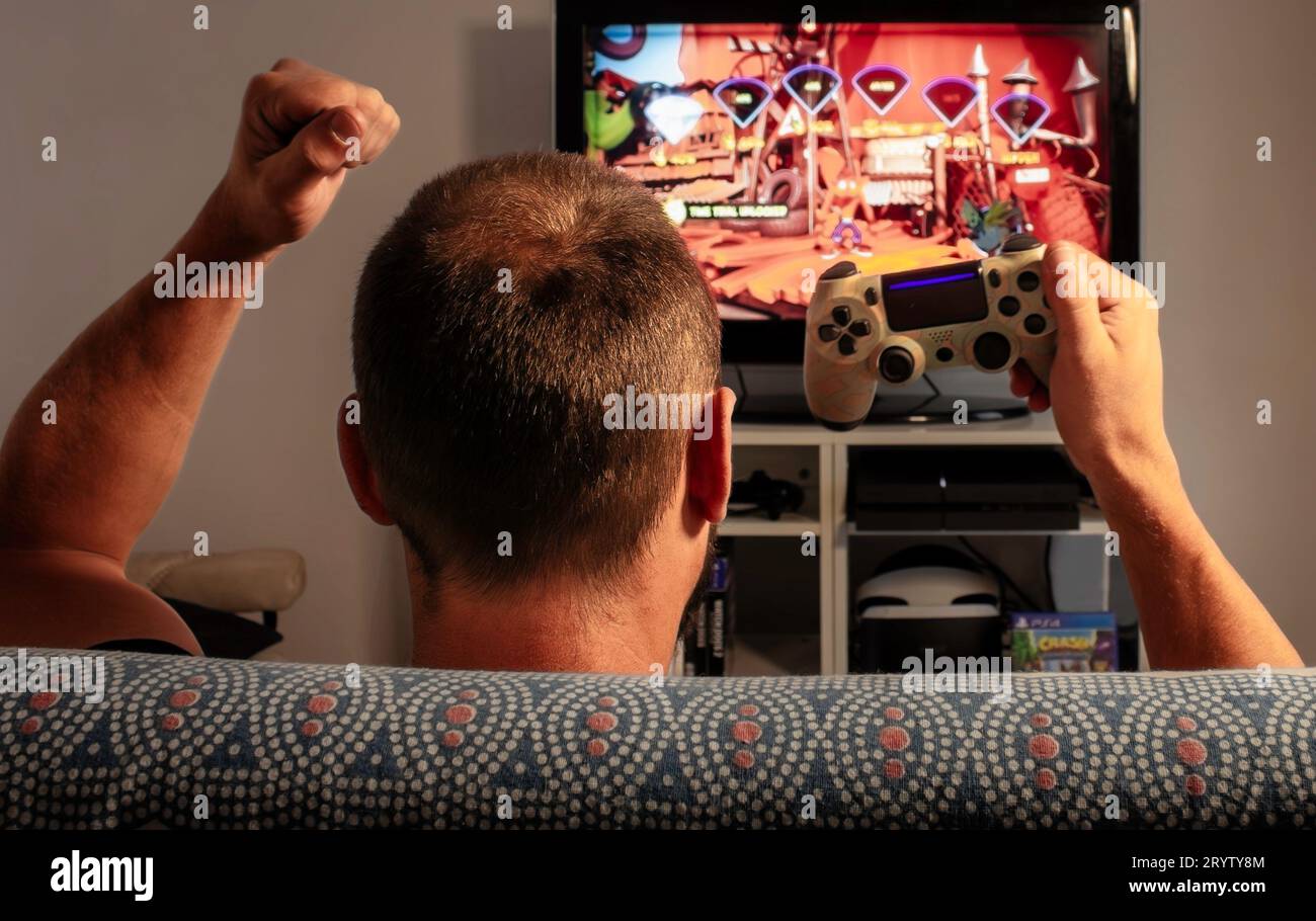 Man celebrates a win on a video game Stock Photo