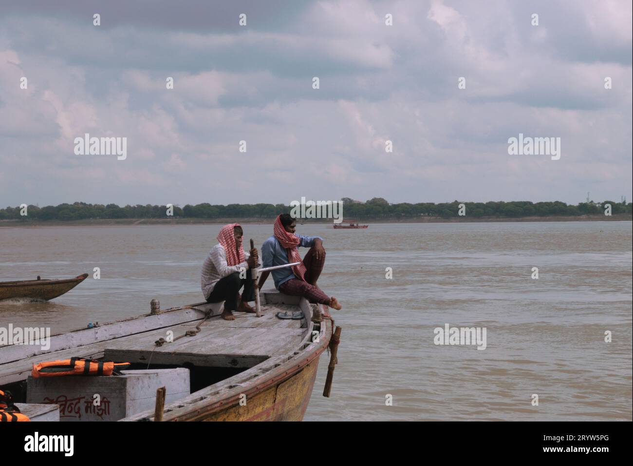 2 men on a boat in the Ganges river in Varanasi. Stock Photo