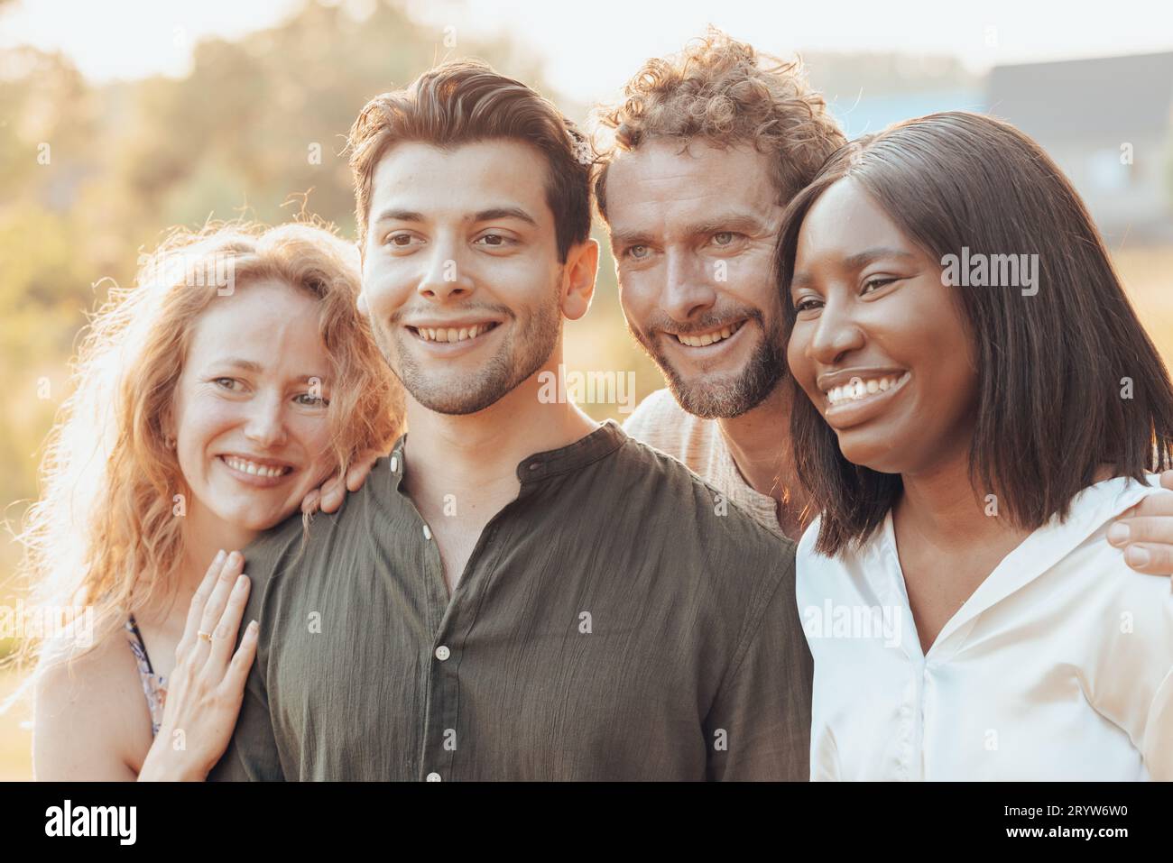 Multiracial group of friends together in outside. Multi ethnic group in in a garden on a sunny day. Friendship and lifestyle con Stock Photo
