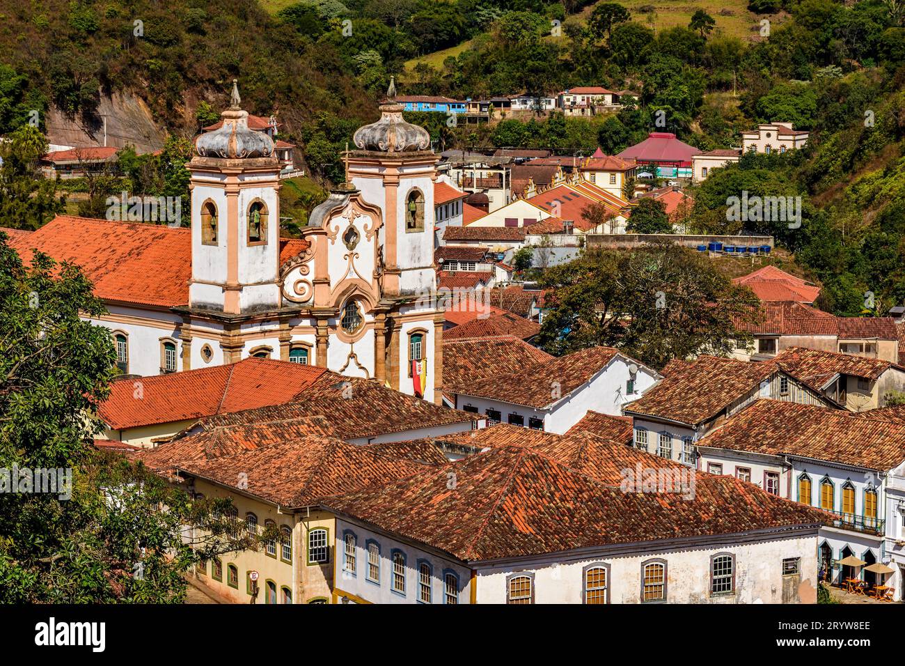 Historic houses and churches among the hills and vegetation Stock Photo