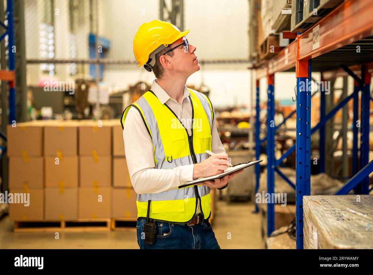 Warehouse workers talking together checking goods in storage Stock Photo