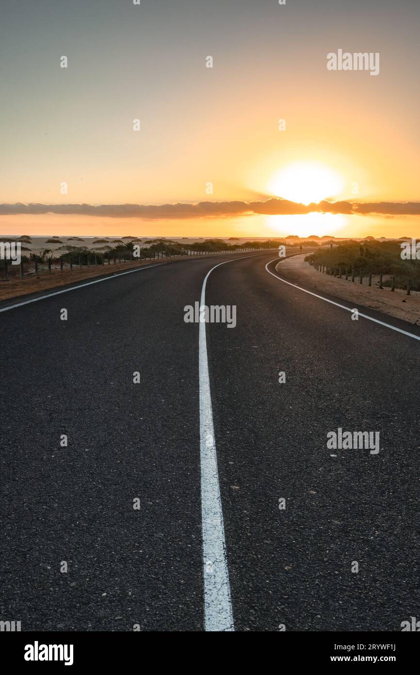 Magical Morning Vibes: The Road Through the Dunes of Corralejo at Sunrise Stock Photo