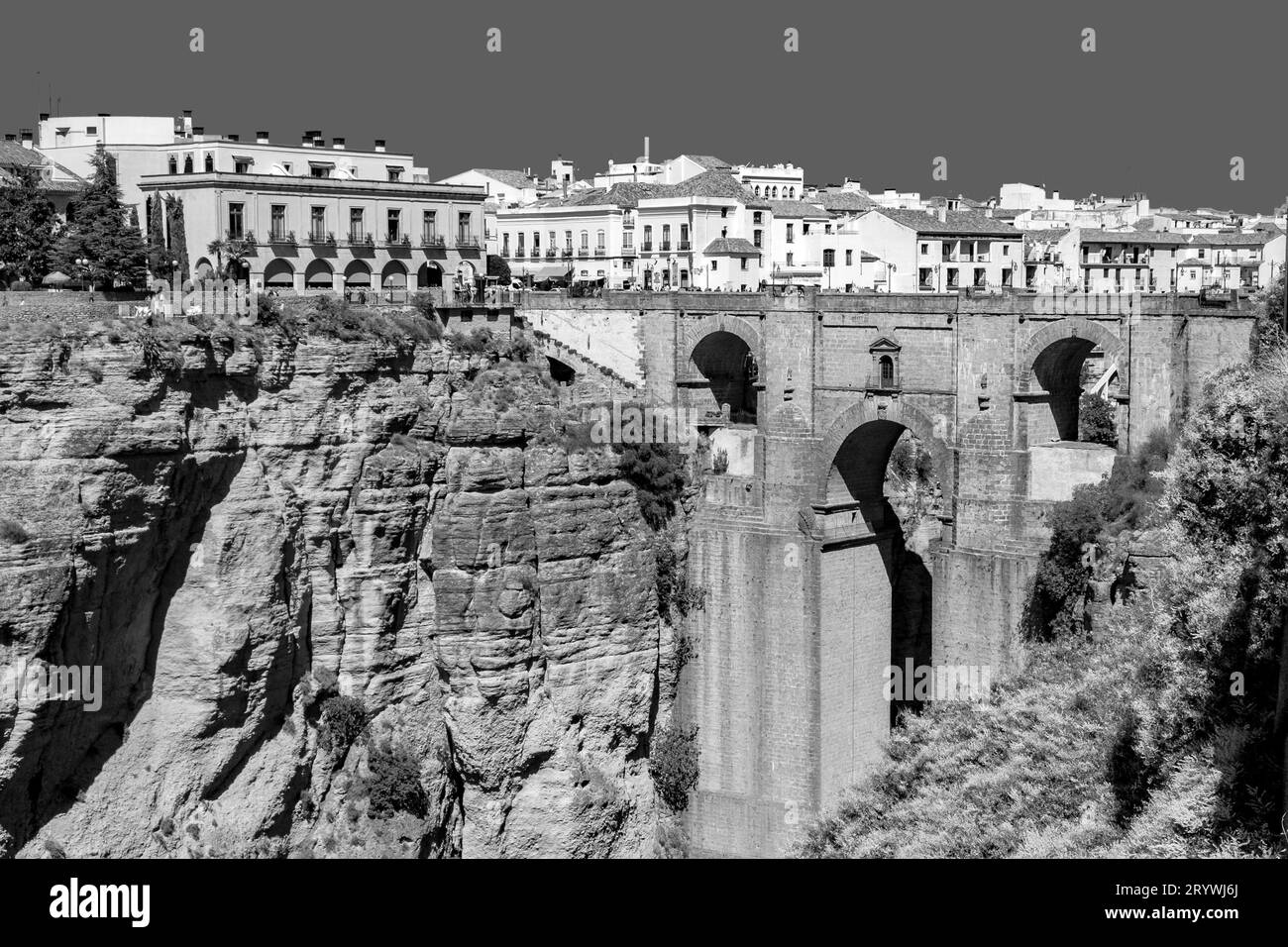 Picturesque view of The Puente Nuevo bridge over a rocky canyon dividing the city of Ronda in Andalusia province. Stock Photo