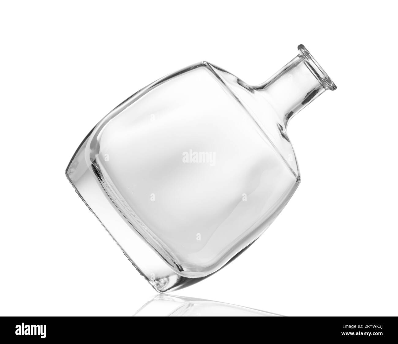 An empty bottle for alcoholic beverages made of transparent glass of a beautiful unusual shape, isolated on a white background. Bottle for cognac Stock Photo
