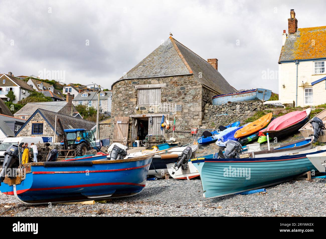 Cadgwith a Cornish village on the Lizard Peninsula is a small fishing port with fishing vessels boats on the working harbour beach, England,UK Stock Photo