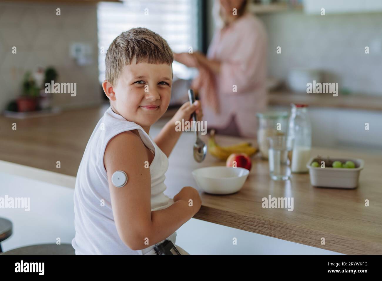 Diabetic boy with a continuous glucose monitor is careful with his diet