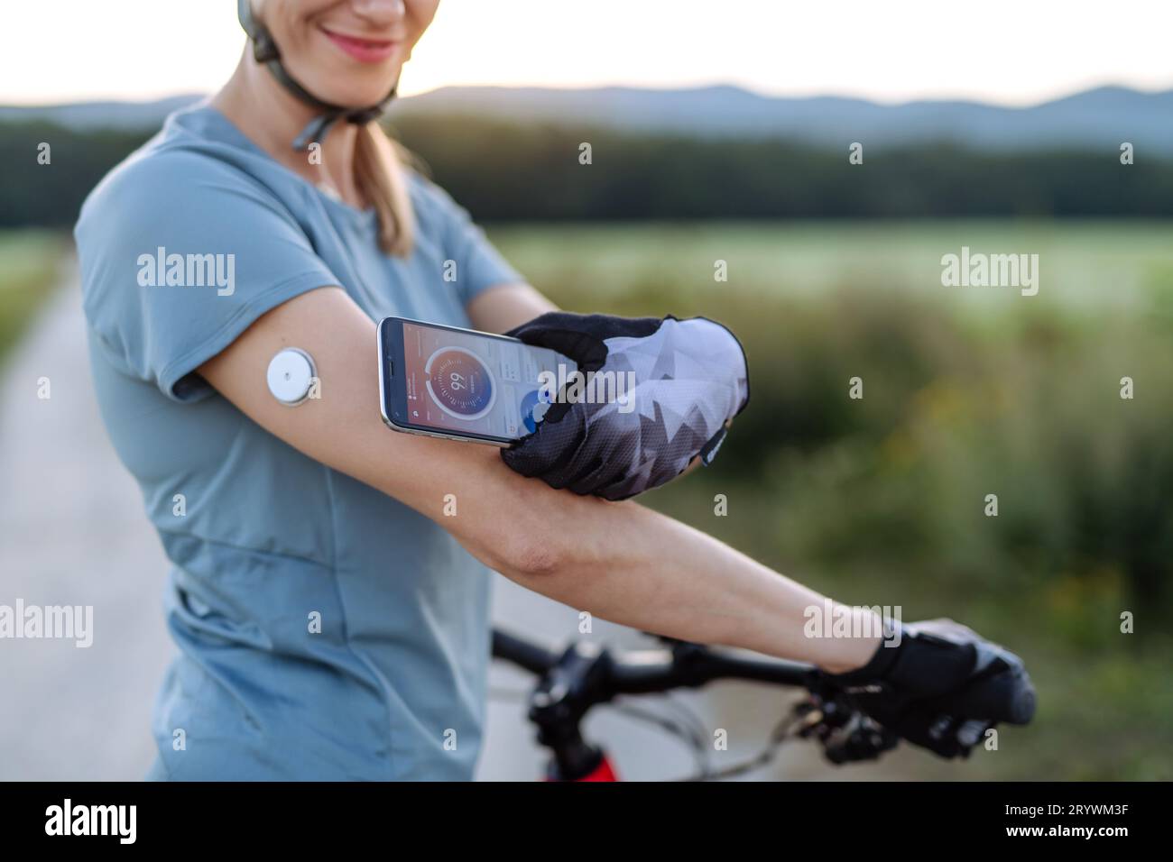 Diabetic cyclist connecting continuous glucose monitor with her