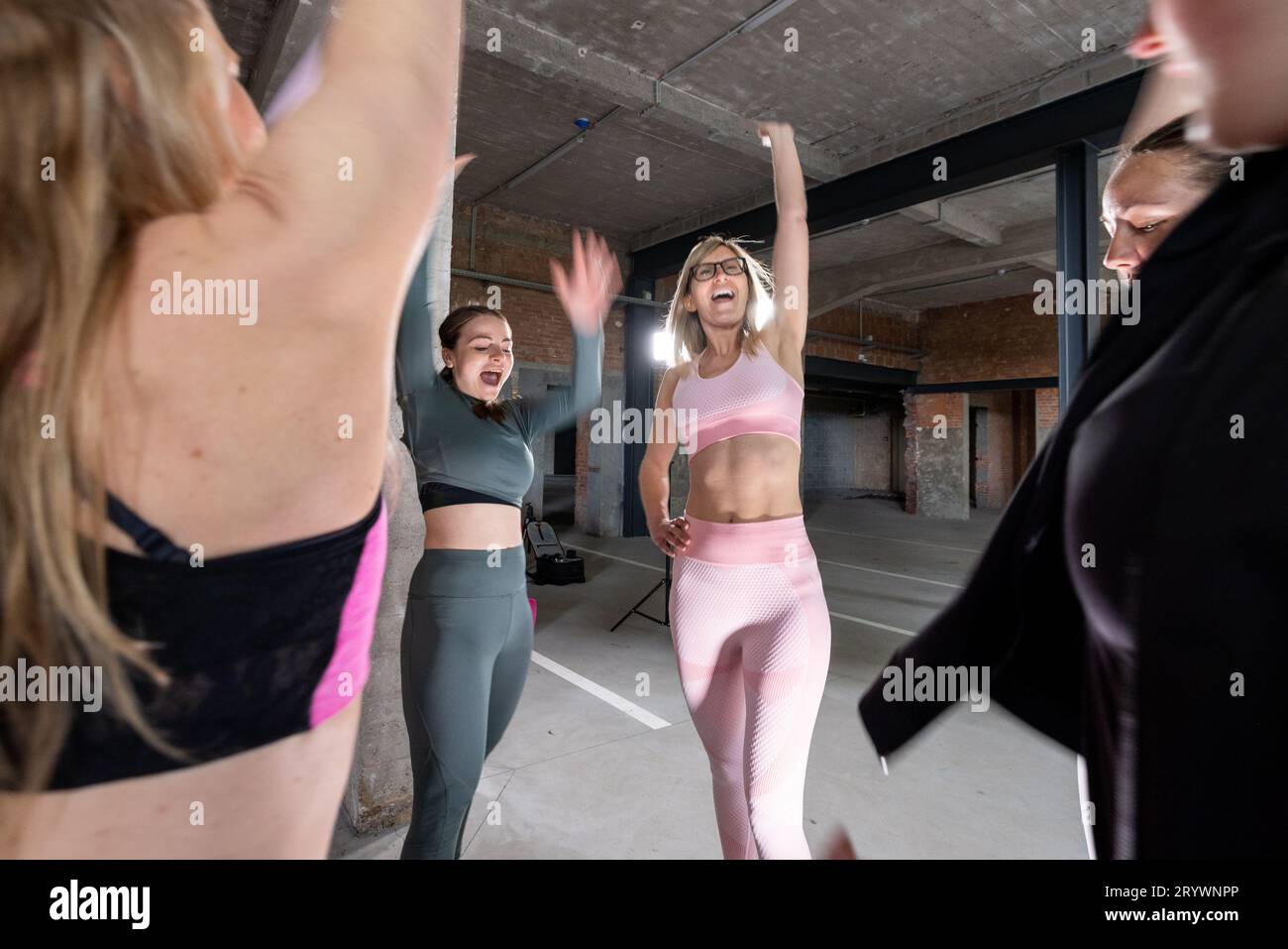 Group of Young Women Cheering After Workout in Sports Attire Stock Photo