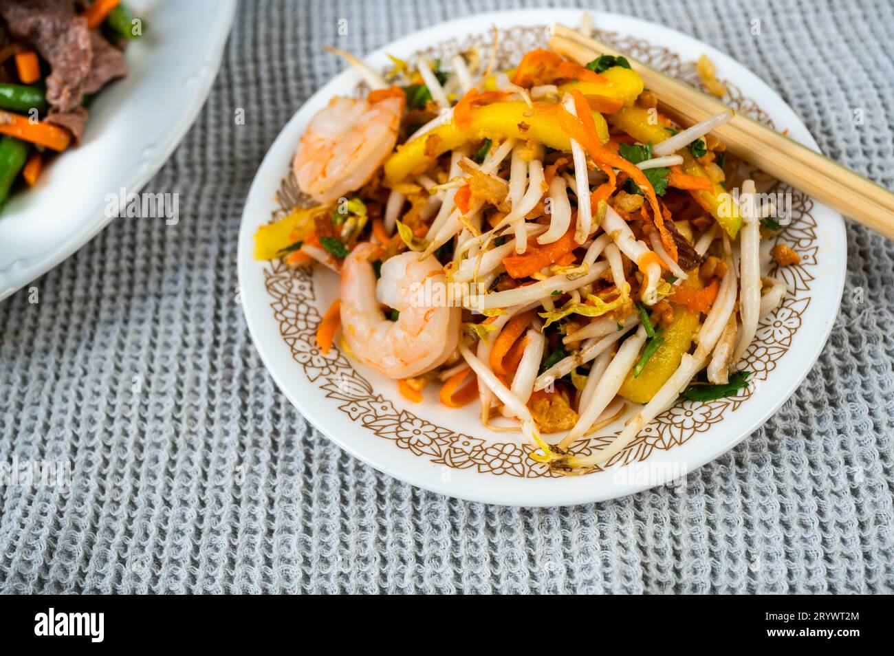 Mango salad with vegetable and shrimp, chopstick. Vietnamese appetizer. Stock Photo