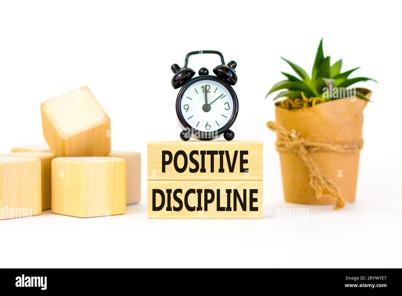 Positive discipline symbol. Concept words Positive discipline on beautiful wooden blocks. Beautiful white background. Black alarm clock. Business psyc Stock Photo