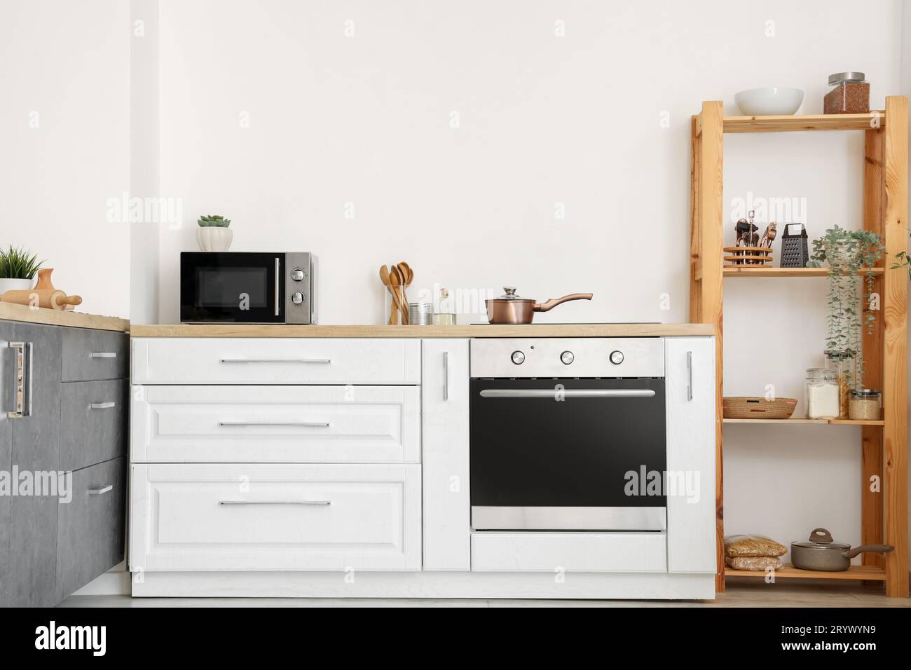 Interior of light kitchen with white counters and shelf unit Stock ...