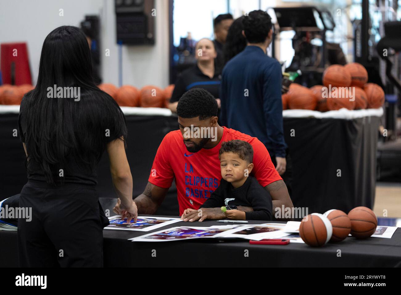 Los Angeles Clippers forward Paul autographs his photos with his