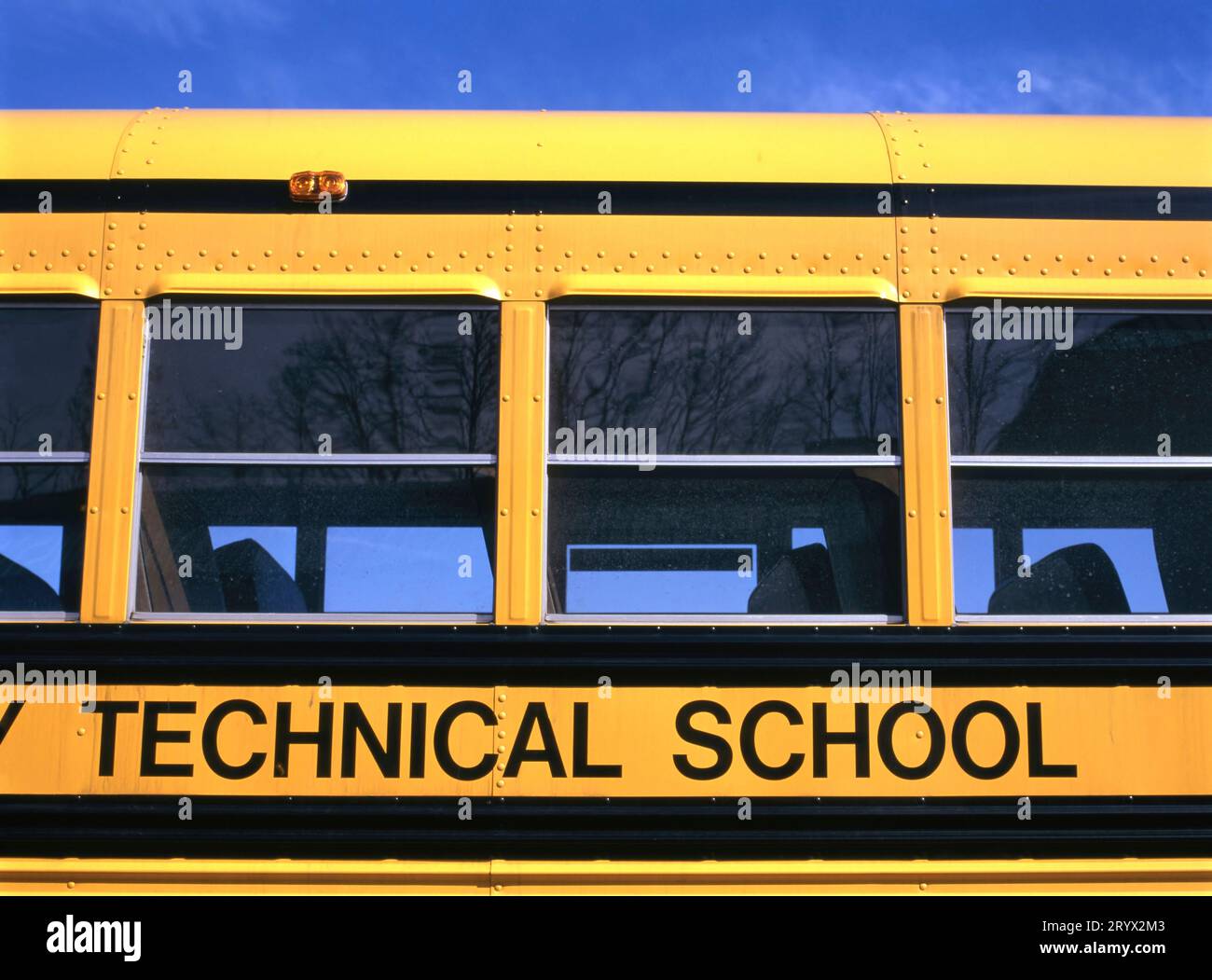 Side view of a yellow school bus for a technical school in The United States of America, USA Stock Photo