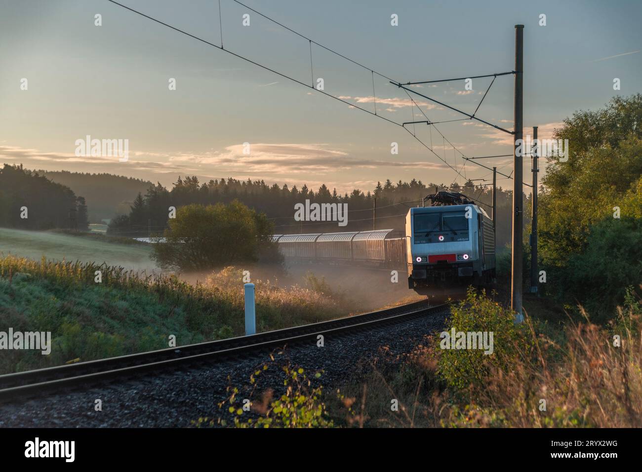 Cargo train in foggy color autumn morning near Horni Dvoriste station near border of Austria Stock Photo