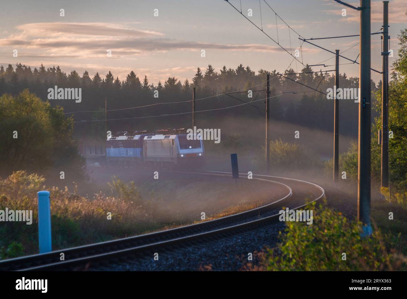 Cargo train in foggy color autumn morning near Horni Dvoriste station near border of Austria Stock Photo