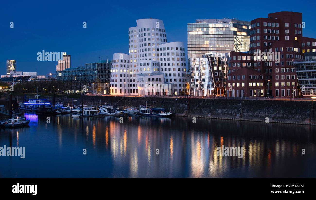 Beautiful view of the Gehry buildings at Dusseldorf's media harbor at night Stock Photo
