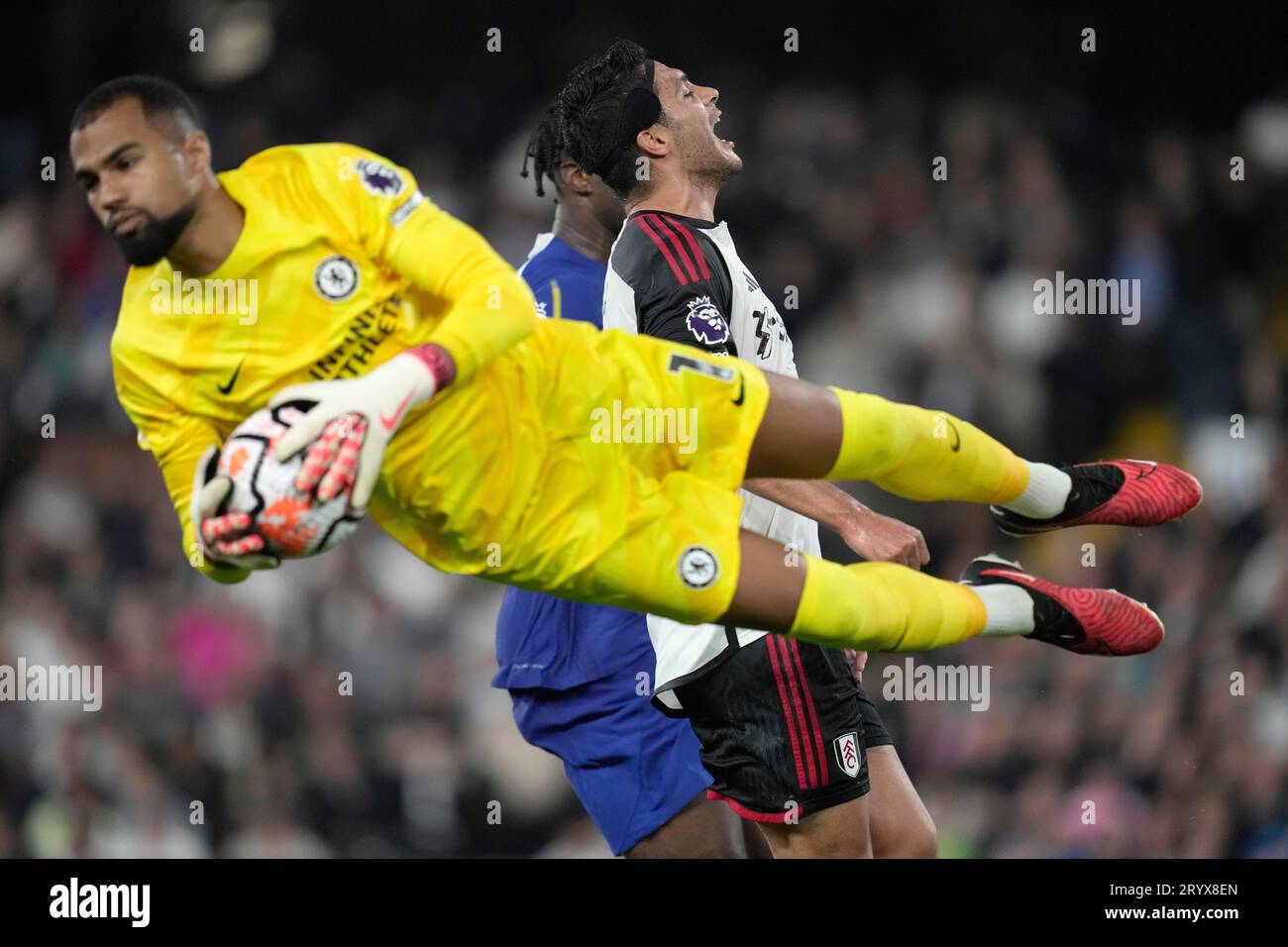 Chelsea's goalkeeper Robert Sanchez makes a save against Fulham's Raul