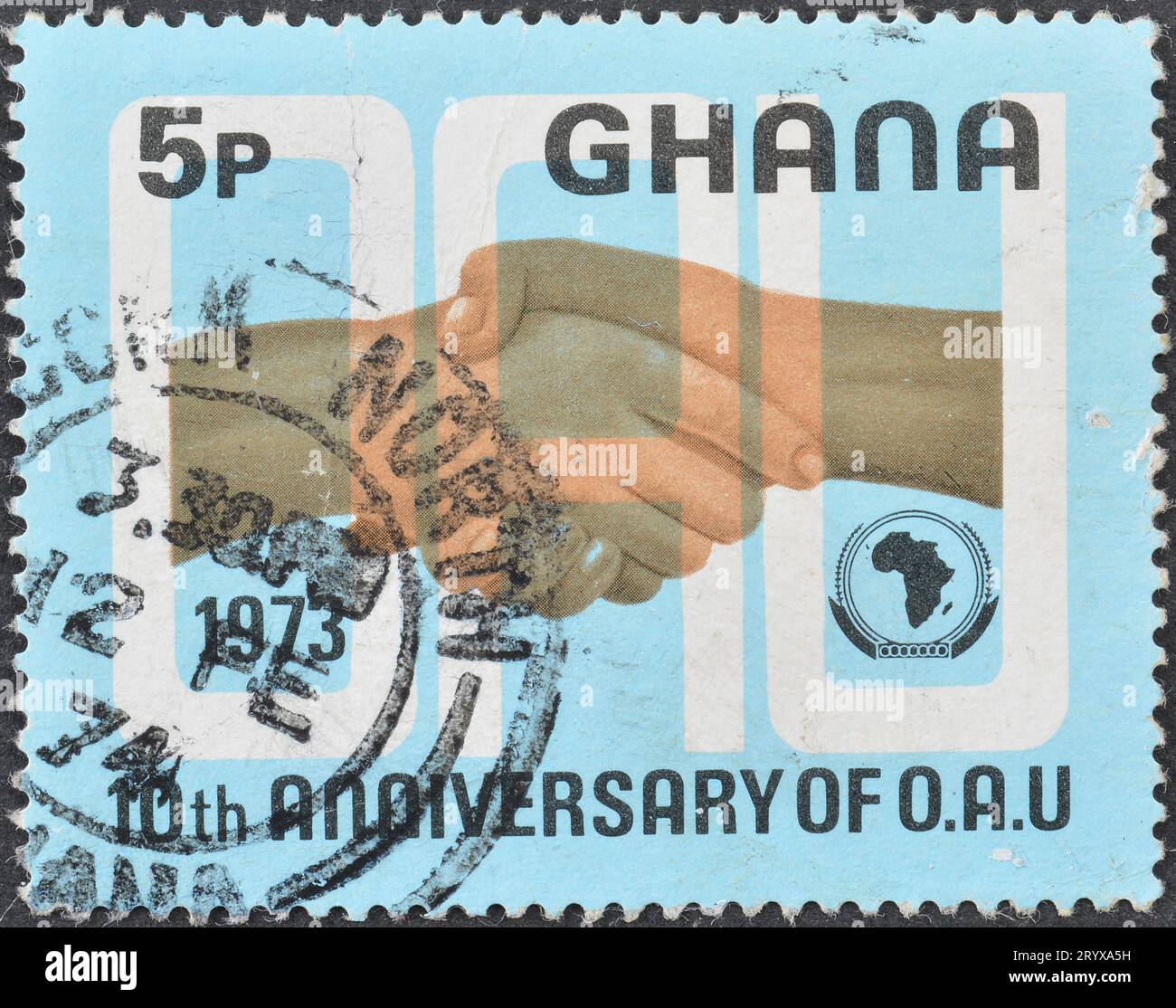 Cancelled postage stamp printed by Ghana, that shows Clasping Hands, Organization African Unity, circa 1973. Stock Photo