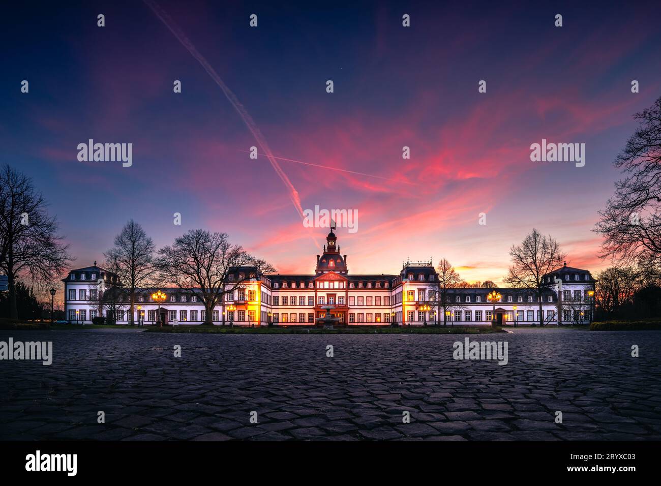 Magical Moment: Schloss Philippsruhe at Sunset by the Main River Stock Photo