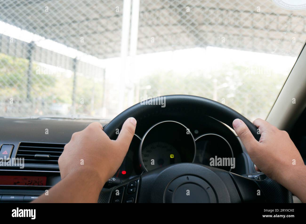 Man driving with both hands on steering wheel selective focus. safety