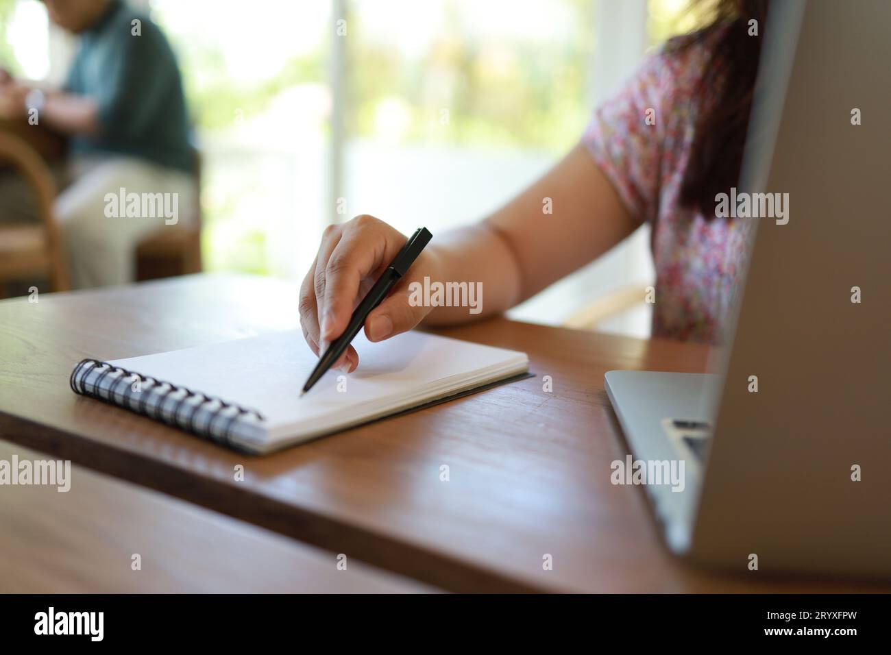 Woman working in cafe coronavirus COVID-19 Social distancing  keep distance in public society people to protect COVID Stock Photo