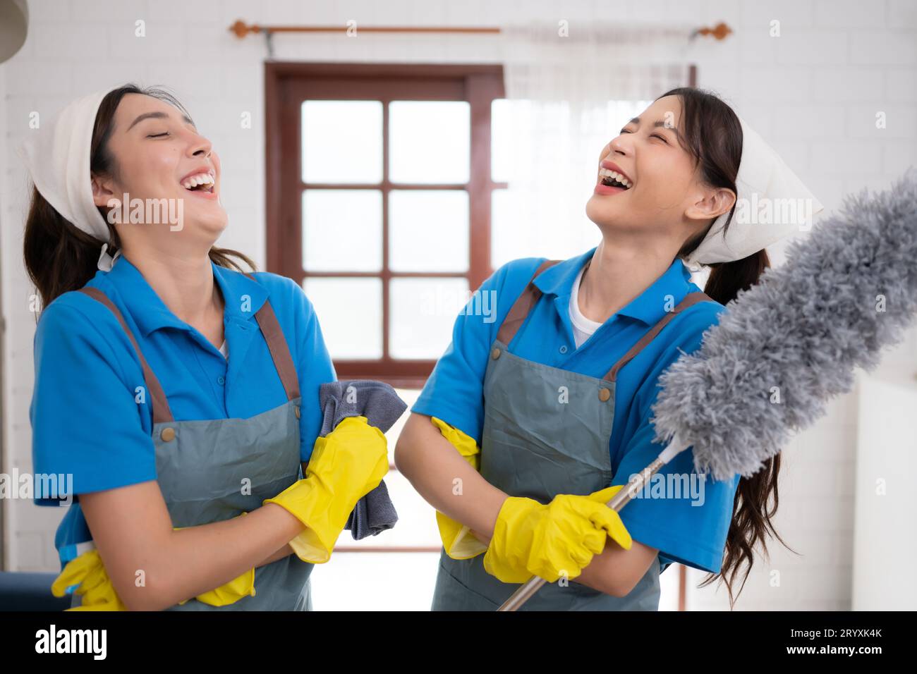 Portrait of asian female cleaning service staff in uniform and rubber