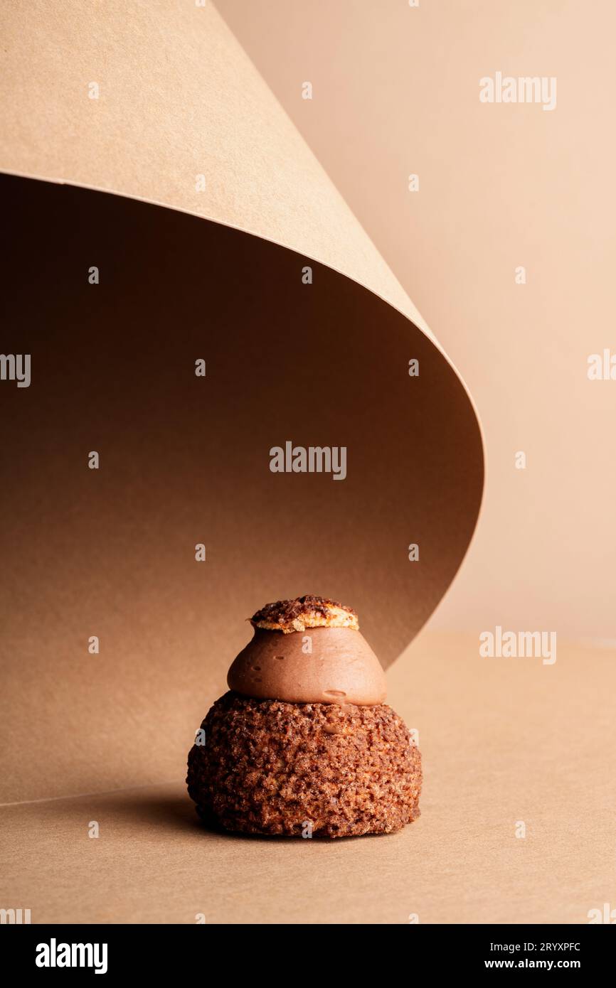 A decadent chocolate cake on a piece of parchment paper, ready to be enjoyed Stock Photo