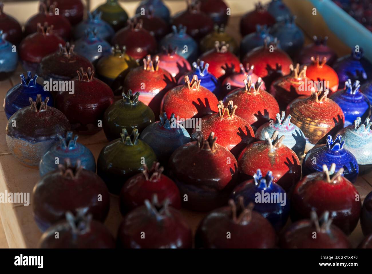 Red ceramic pomegranate - symbol of Israel for sale at the market Stock Photo