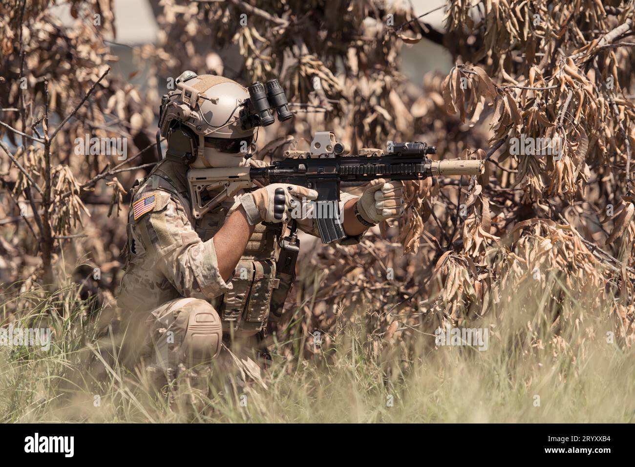Special forces soldier in camouflage with a pair of weapons that are ...