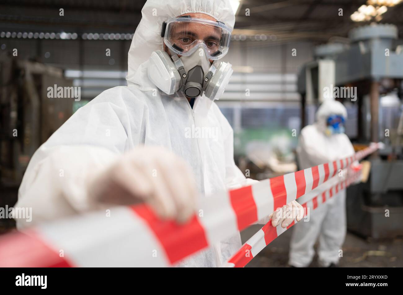 Restricted area, officials employ white and red stripes to block the area where a chemical leak is occurring. To prevent individ Stock Photo