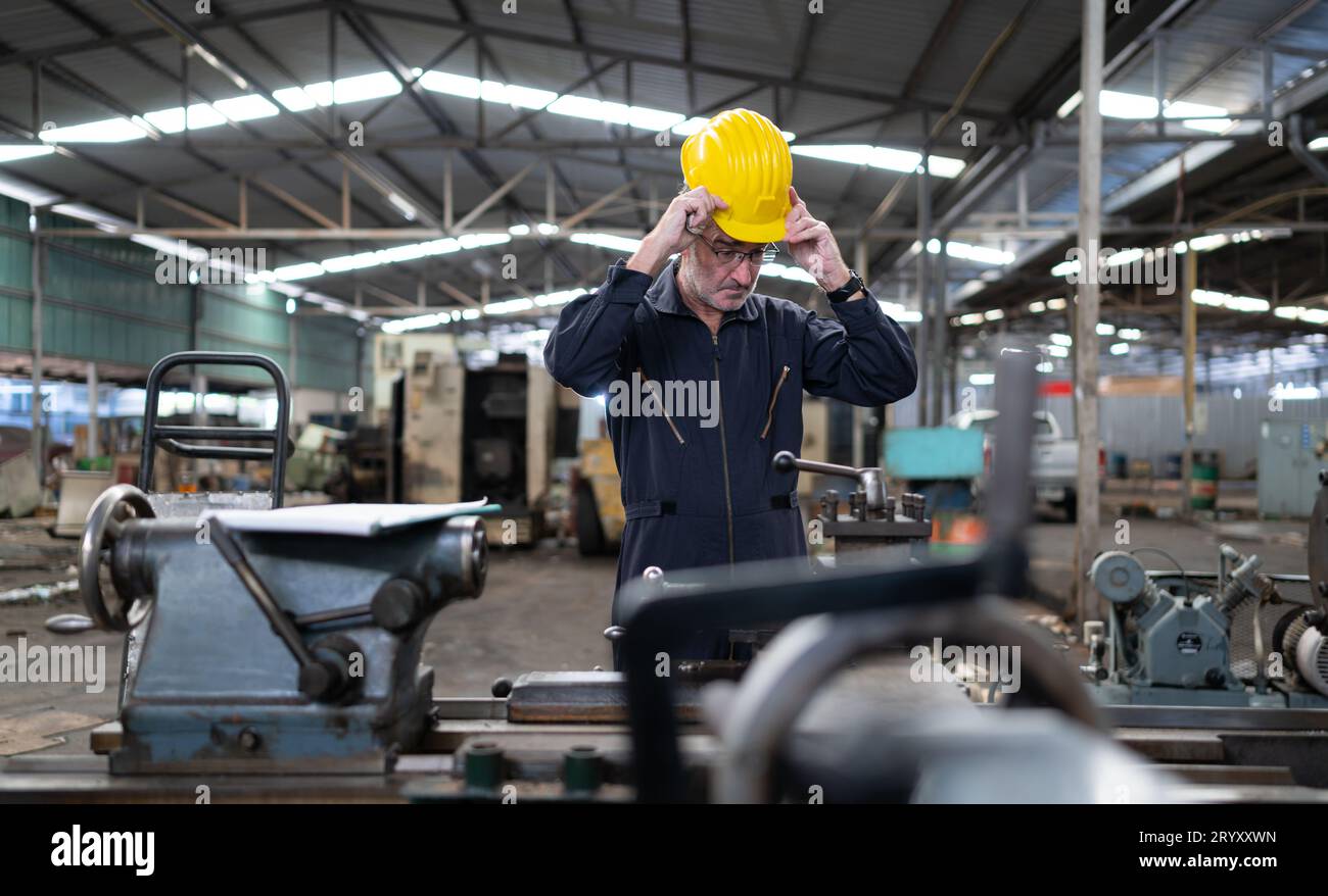 Senior engineer with fatigue from long and hard work Stock Photo