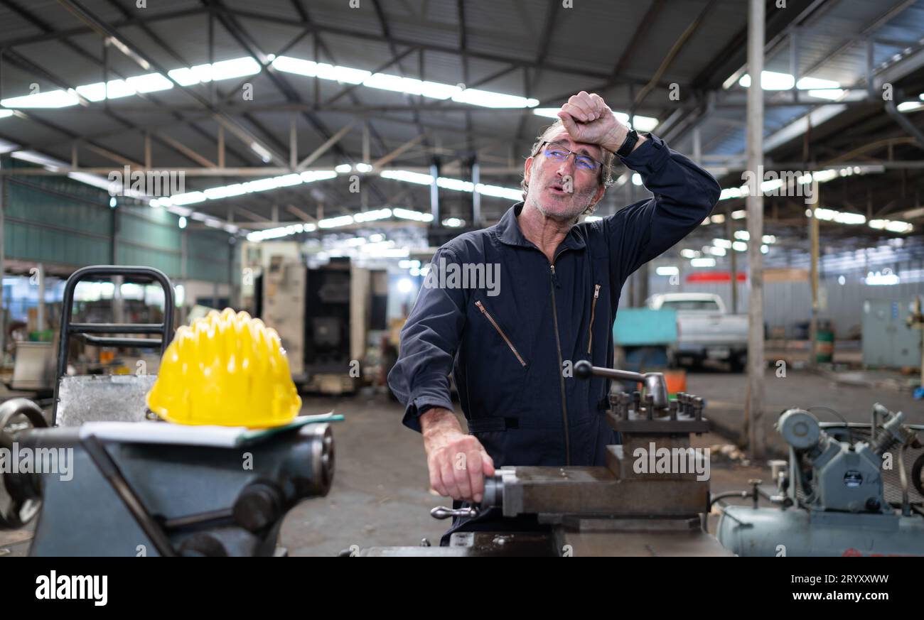 Senior engineer with fatigue from long and hard work Stock Photo