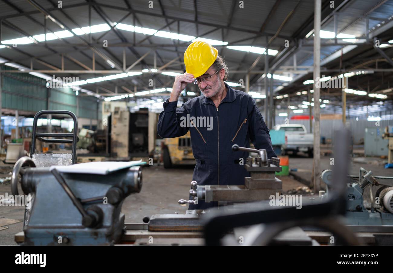 Senior engineer with fatigue from long and hard work Stock Photo