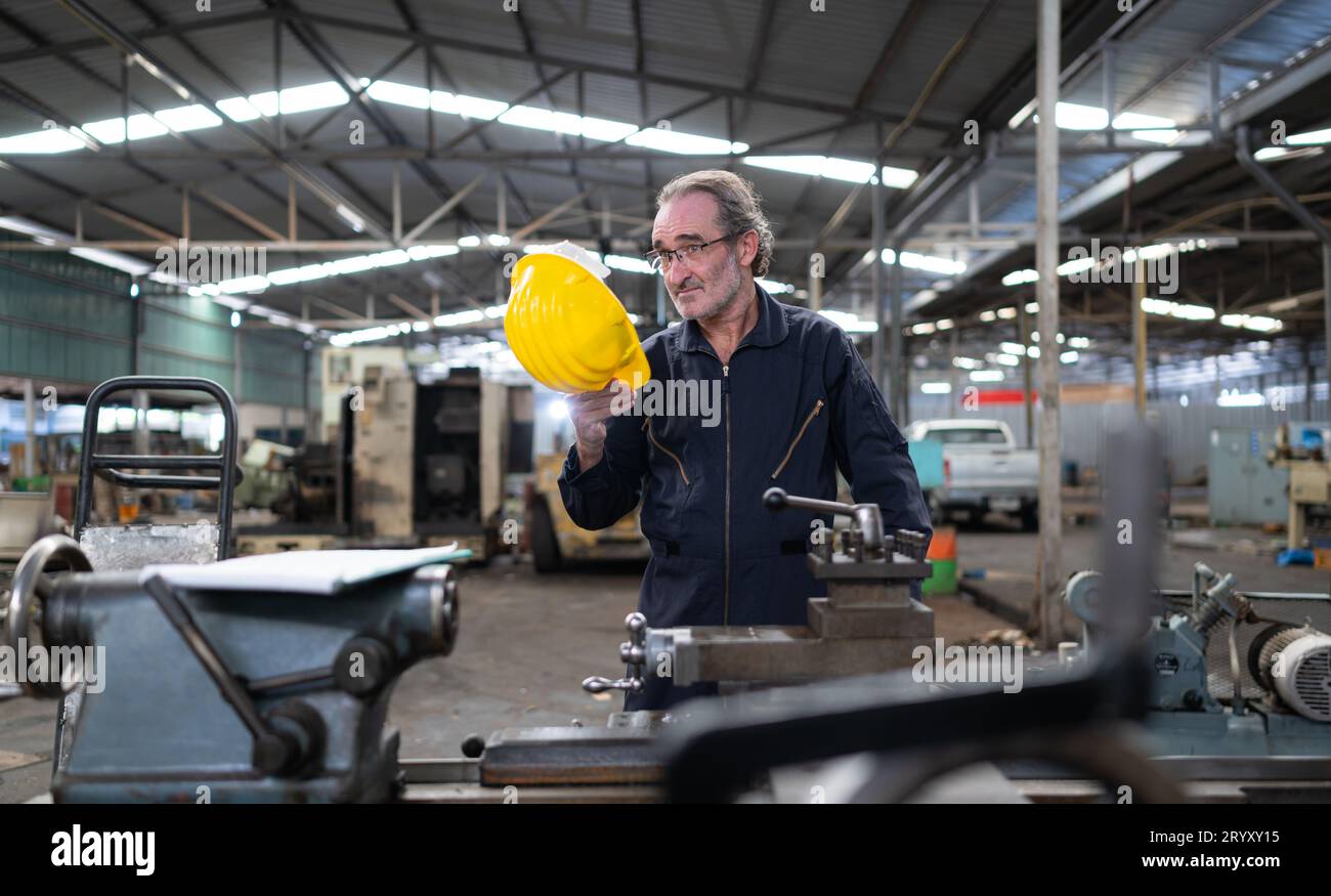 Senior engineer with fatigue from long and hard work Stock Photo