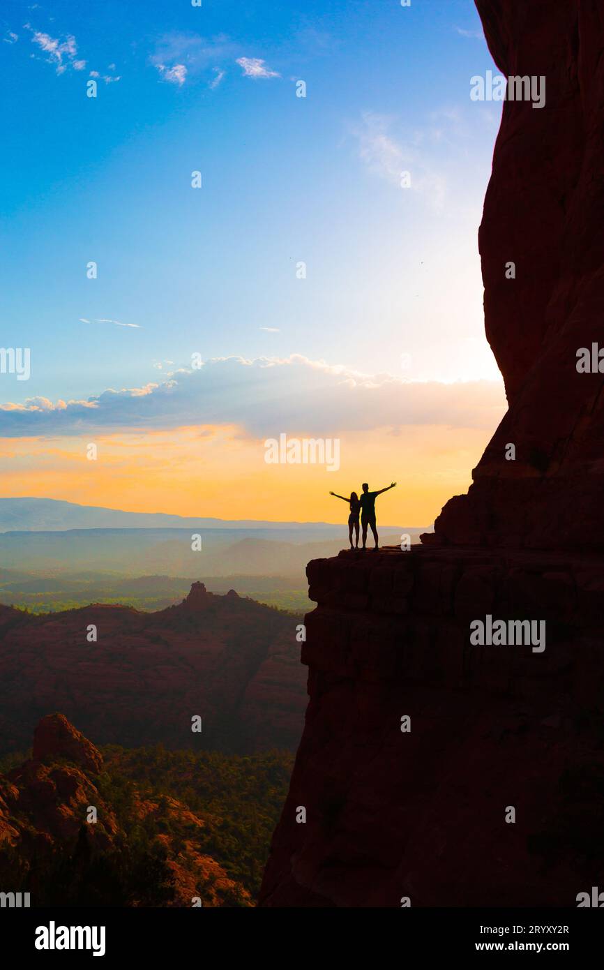 Silhouette of father and his daughter on the trail at Cathedral Rock at sunset in Sedona. The colorful sunset over Sedona's Cath Stock Photo