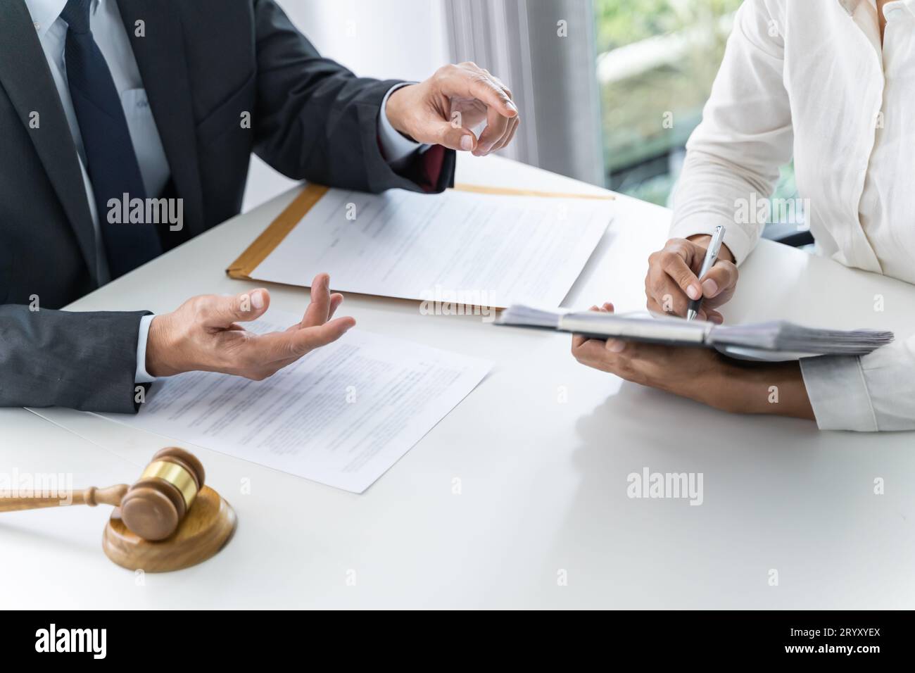 Legal counsel presents to the client a signed contract with gavel and legal law. justice and