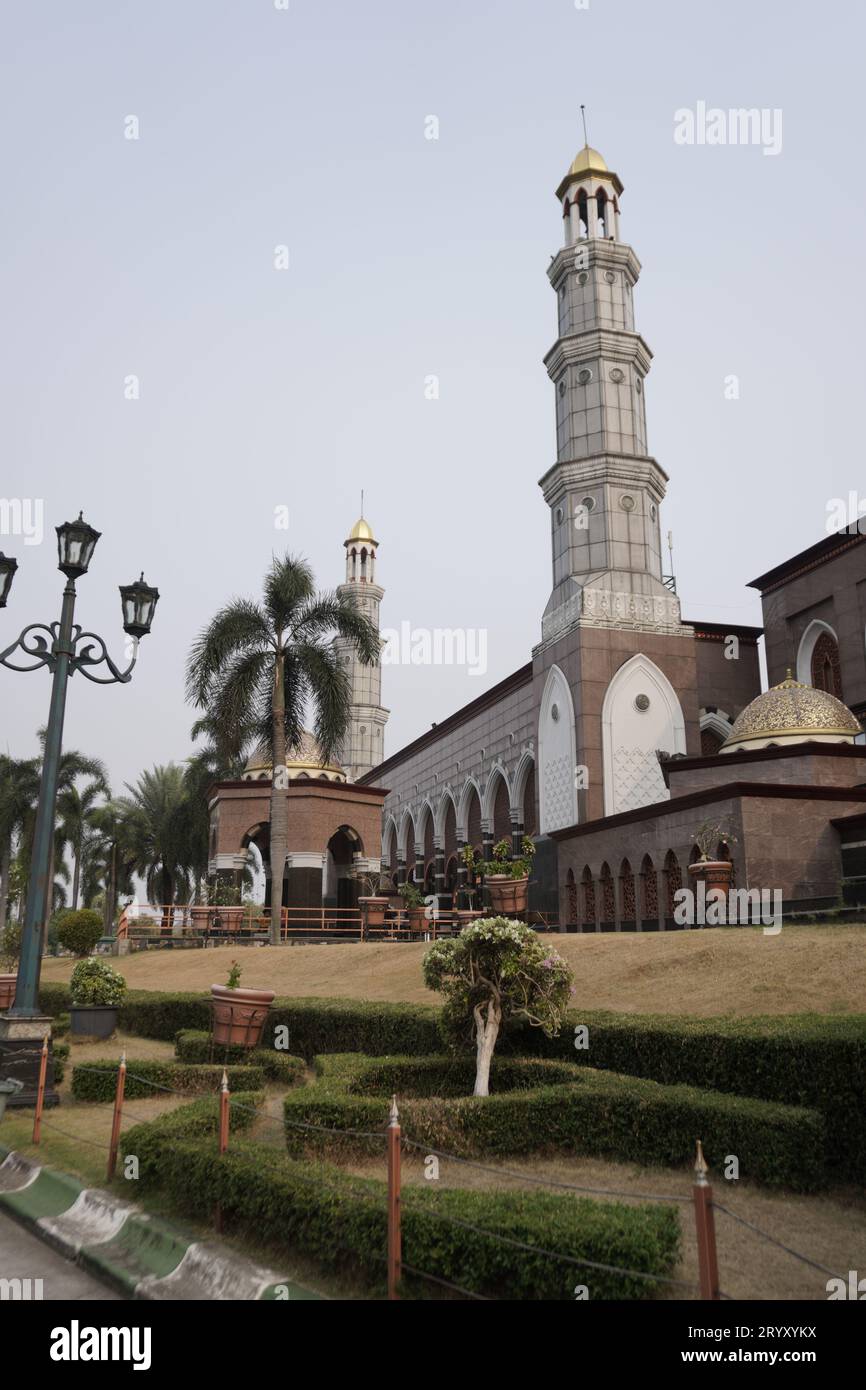 The mosque building with a golden yellow dome appears under a clear sky. Stock Photo