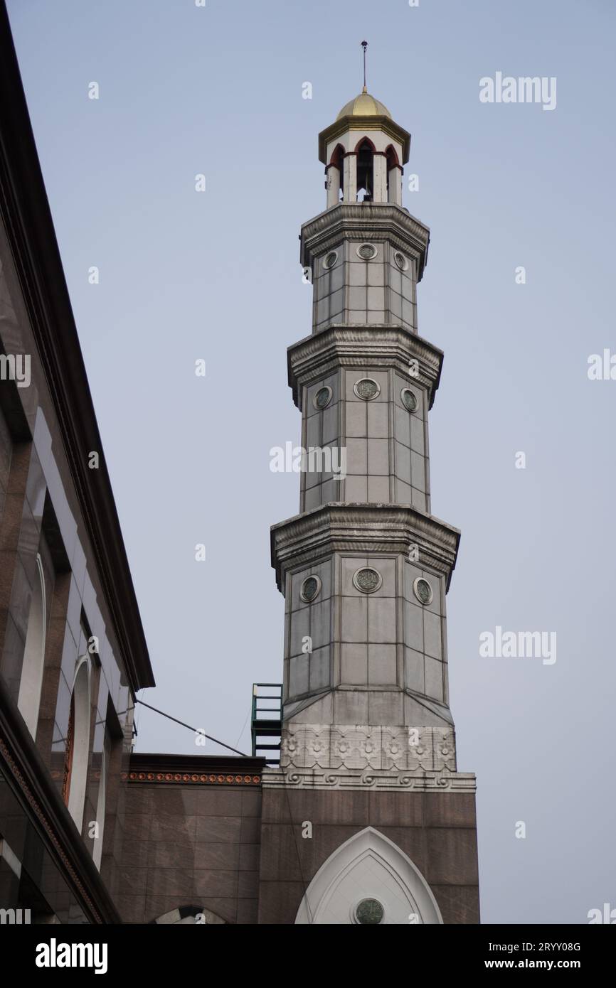 The beautiful mosque tower is green, with garden lights. sky background in the afternoon. Stock Photo