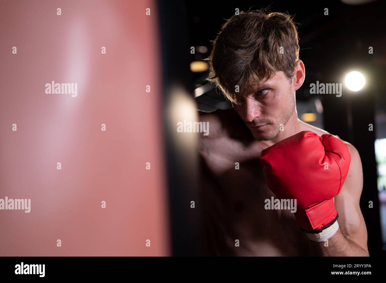 Portrait of boxers must practice their kicking and punching skills with punching bag. To build strength and power of kicking and Stock Photo