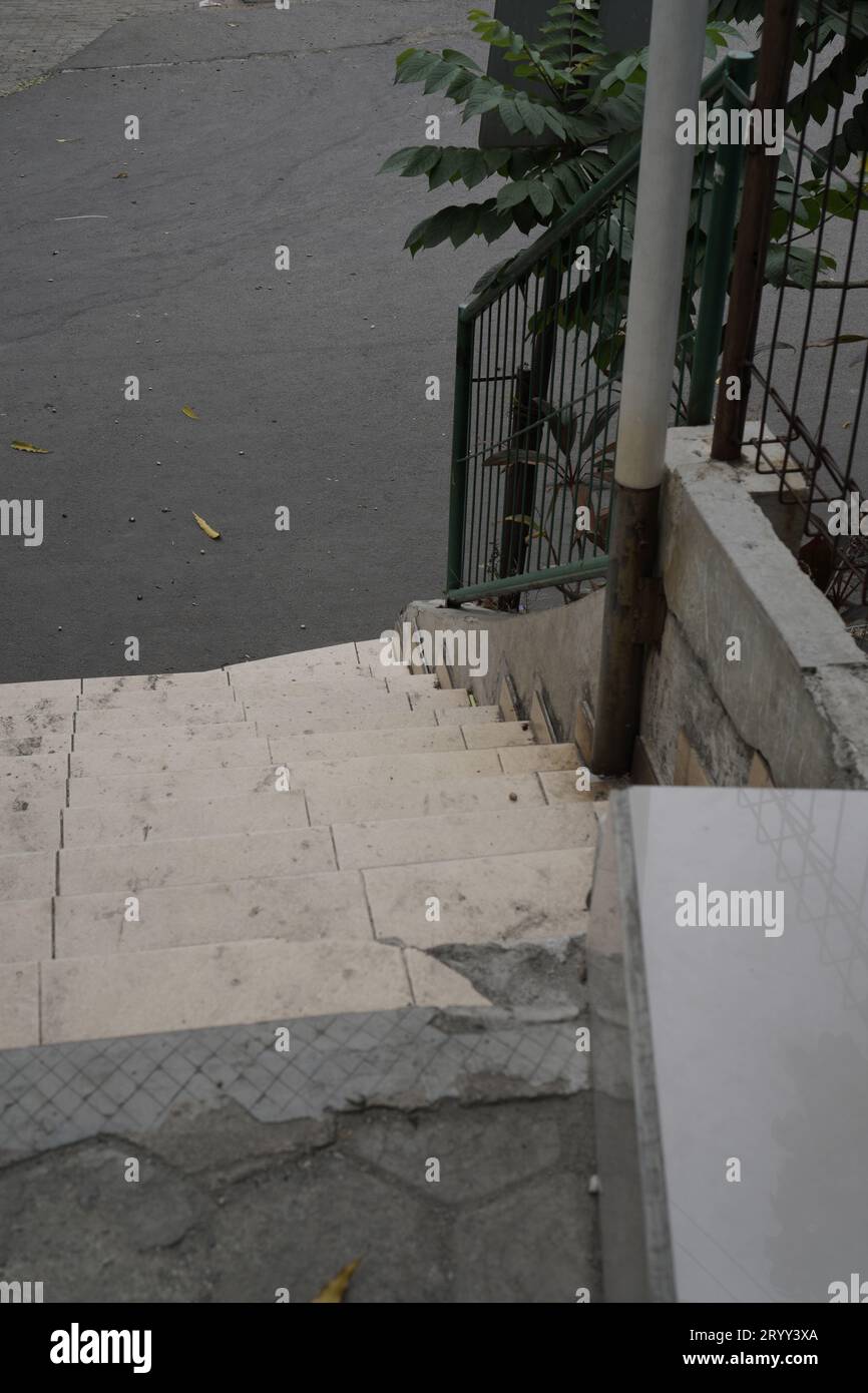 steps with iron railings, seen from above leading downwards. Stock Photo
