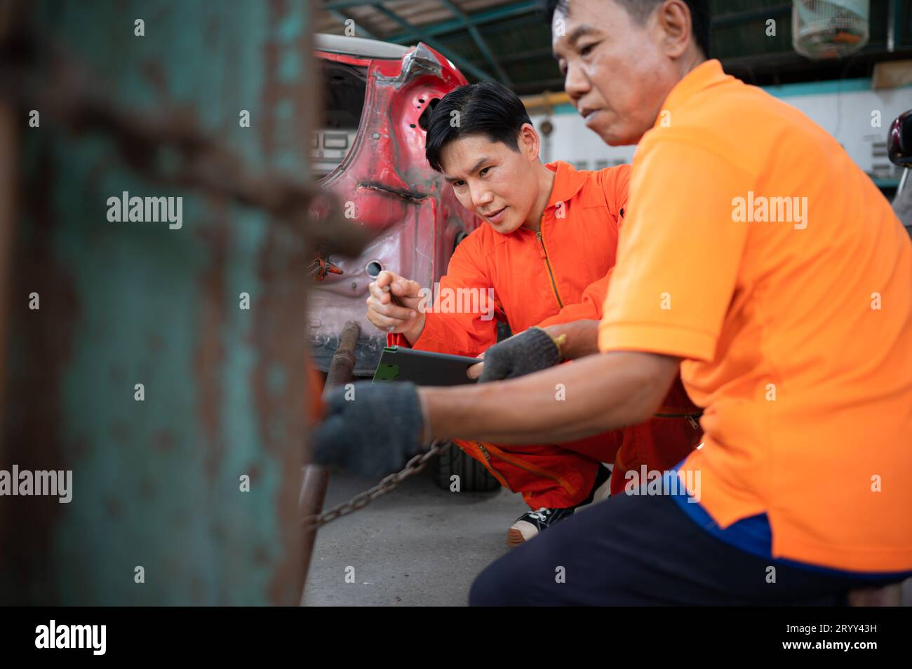 To return the automobile body to its former shape, an auto repair mechanic uses a machine to