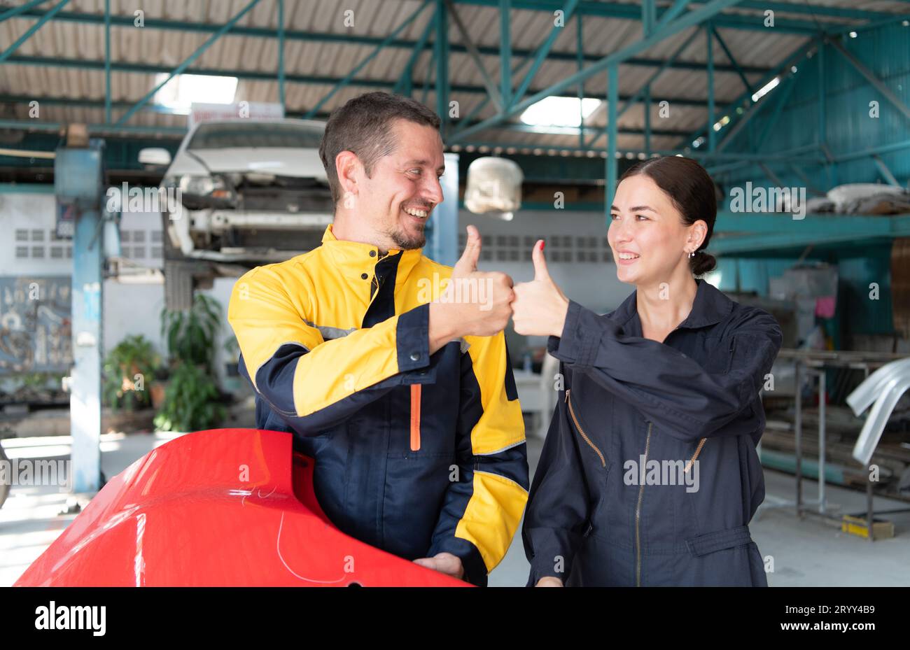 Portrait of engineer and auto mechanic with working on engine repairs