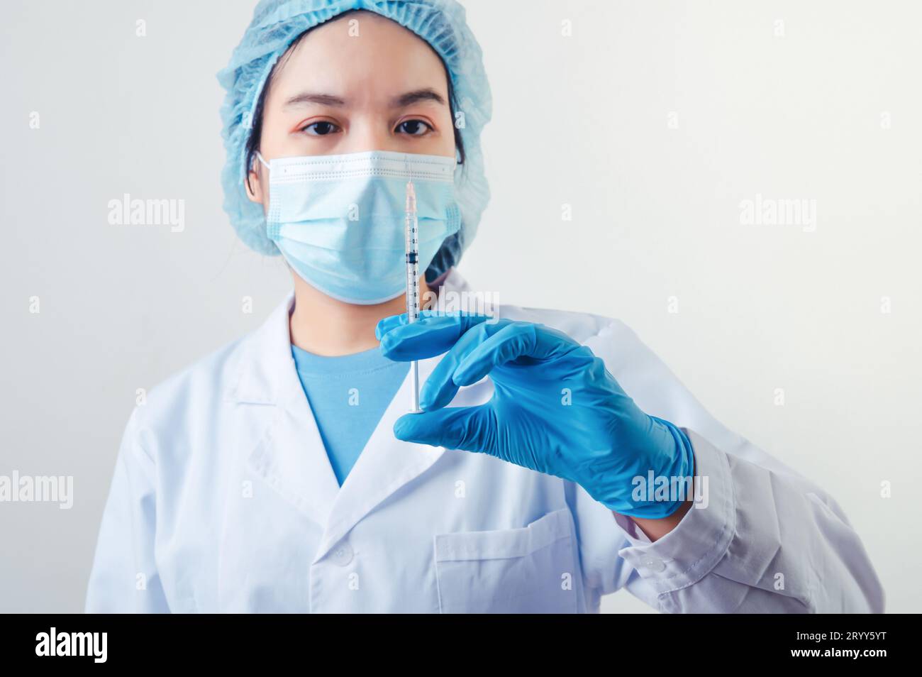 Closeup vial of covid-19 vaccine in hand of professional scientist or doctor in laboratory for treatment with mask gloves and la Stock Photo