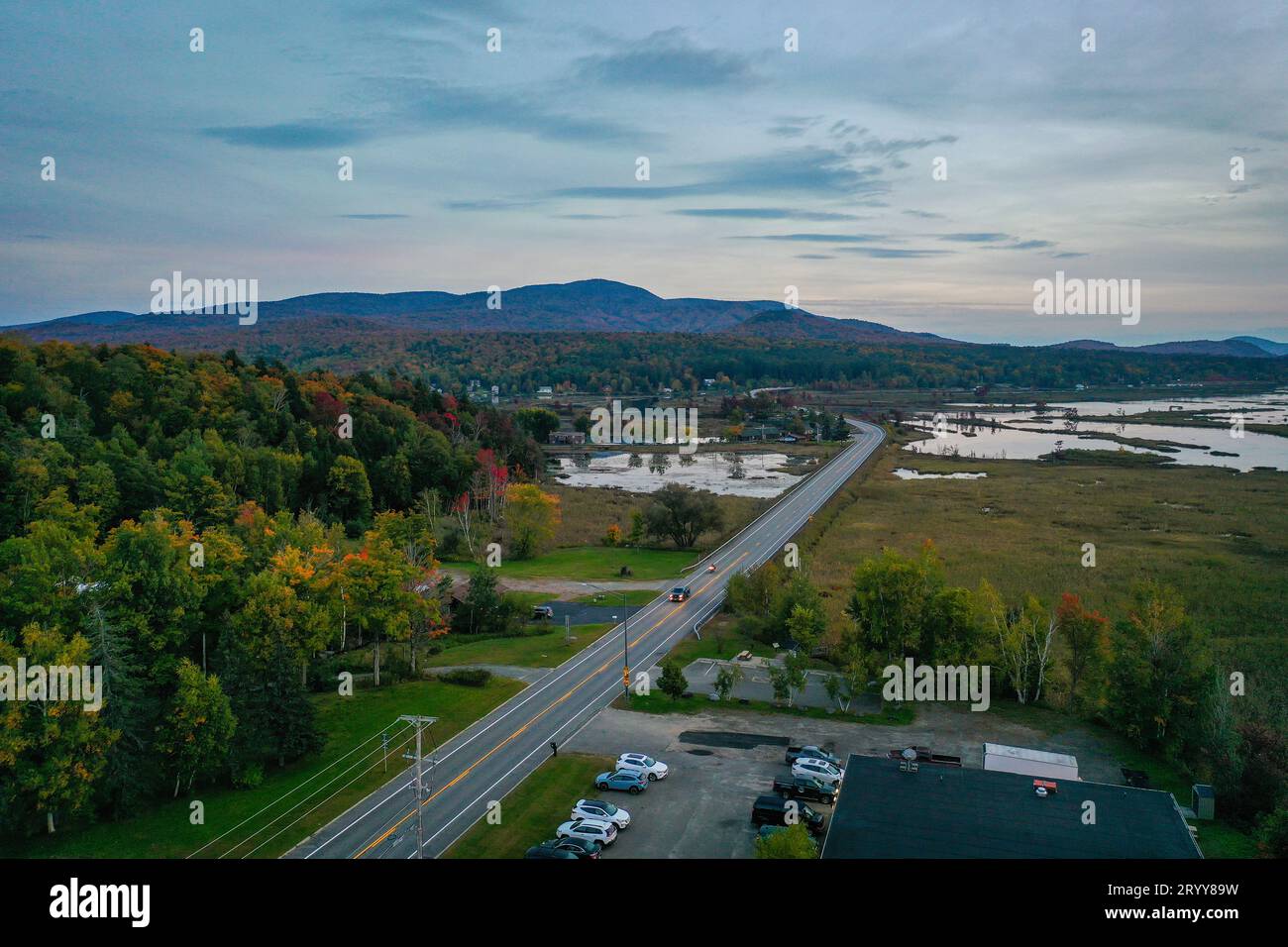 Sunset over Moody Tupper Lake NY Adirondacks in early fall aerial Stock